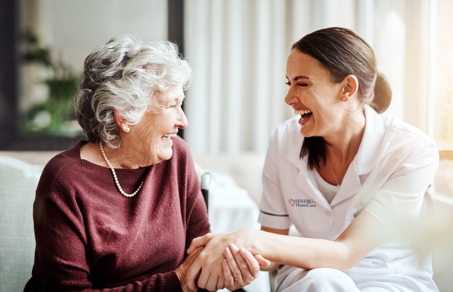 A SYNERGY HomeCare caregiver sharing a laugh with her client
