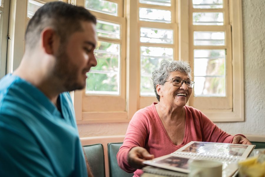A caregiver and client enjoying old photographs together